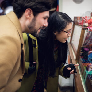 happy couple standing at the gift counter in the supermarket